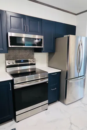 a kitchen with a refrigerator stove and microwave