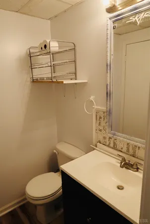 a view of swimming pool with lawn chairs next to yard