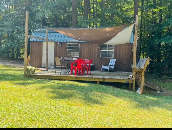 a front view of a house with yard and green space