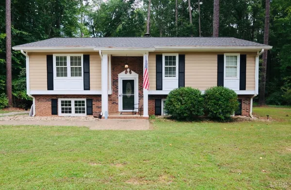 a view of an house with backyard space and deck