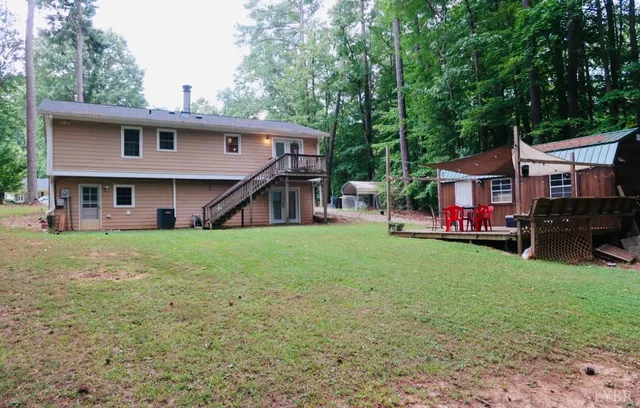 a view of an house with backyard space and deck