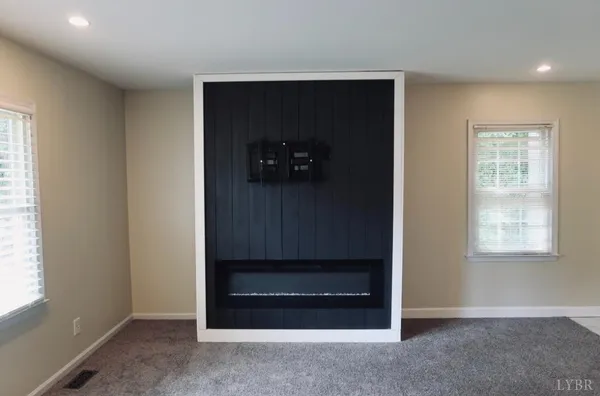 an empty room with windows and closet