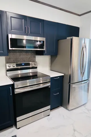 a kitchen with a refrigerator stove and microwave