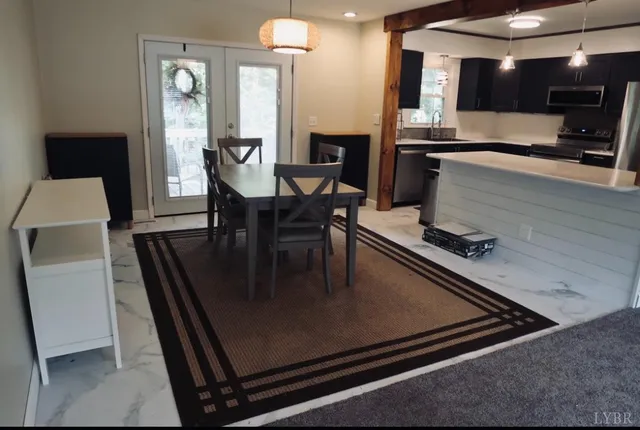 a kitchen with a table chairs and refrigerator