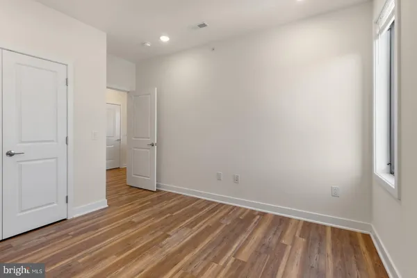 a view of an empty room with wooden floor
