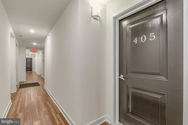 a view of a hallway with wooden floor and staircase