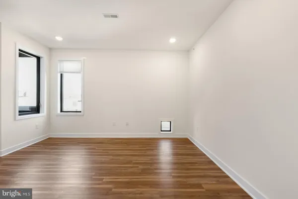 a view of room with window and wooden floor