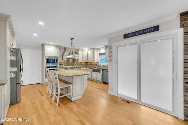 a kitchen with stainless steel appliances a sink a stove and cabinets