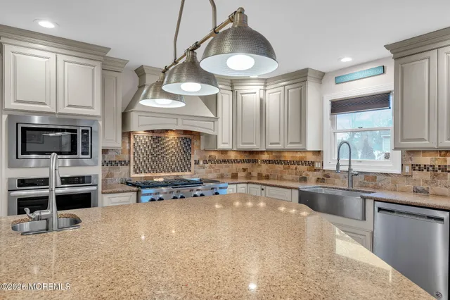a kitchen with stainless steel appliances a stove microwave and cabinets