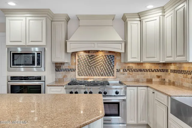 a kitchen with stainless steel appliances granite countertop a stove and a sink