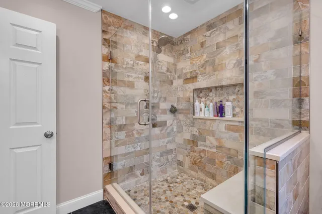 a bedroom with furniture a flat screen tv and a refrigerator