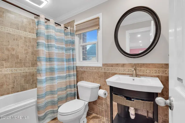 a bedroom with a bed and a lamp on dresser