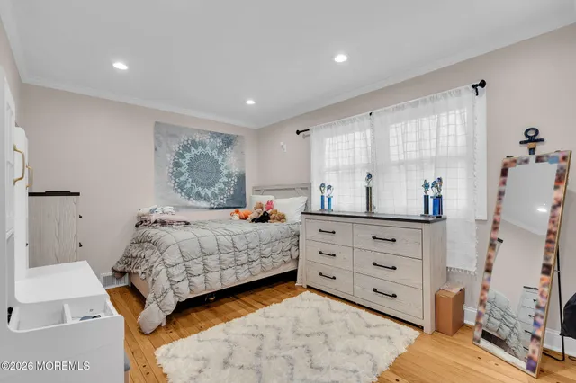 a bedroom with furniture and a wooden floor
