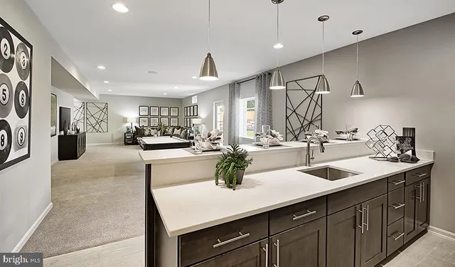 a kitchen with sink refrigerator and cabinets