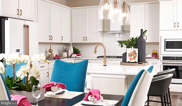 a view of kitchen with sink and refrigerator