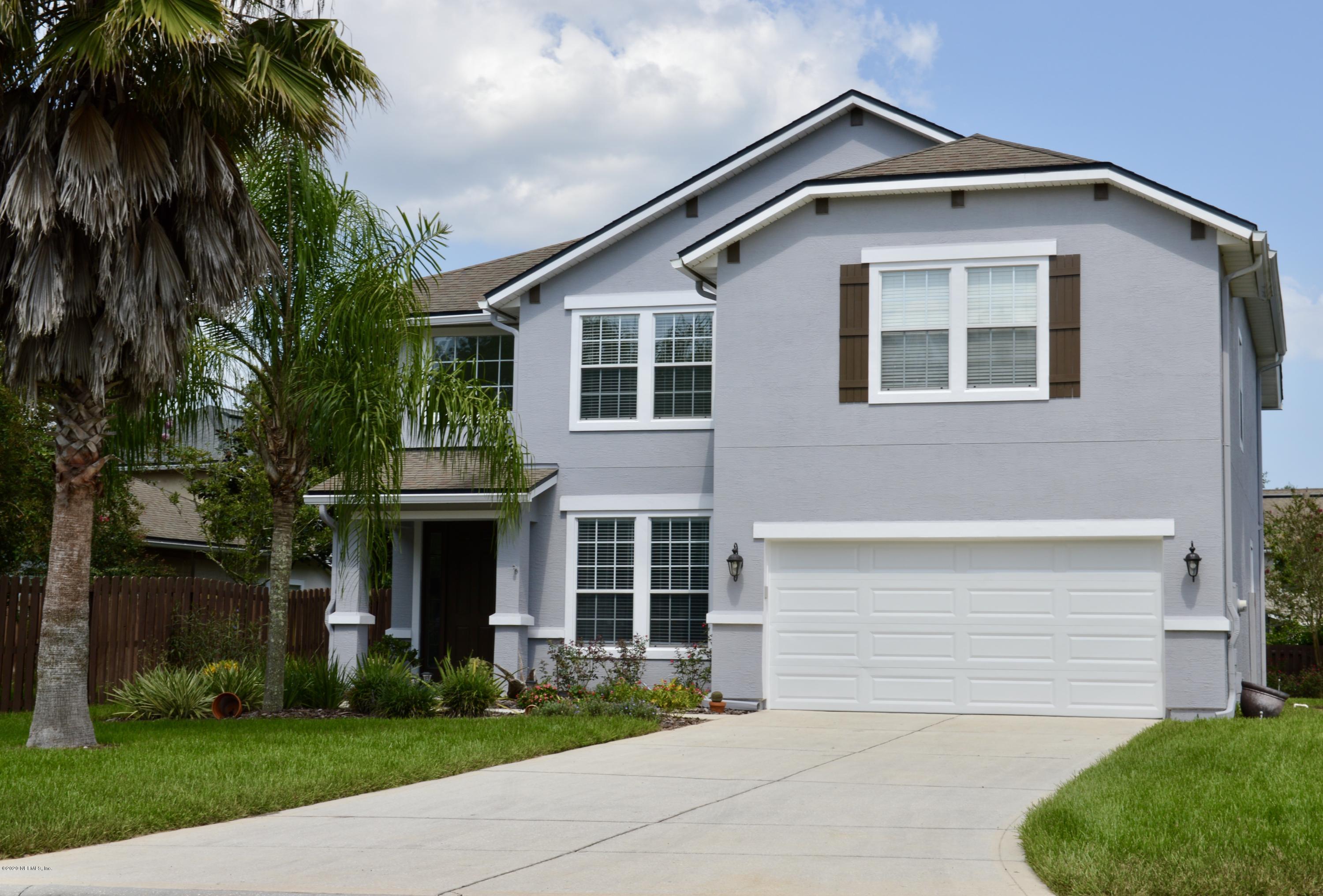 3412 South Saxxon Road St. Augustine, FL 32092 - Photo 2 of 23 a front view of a house with a yard and garage