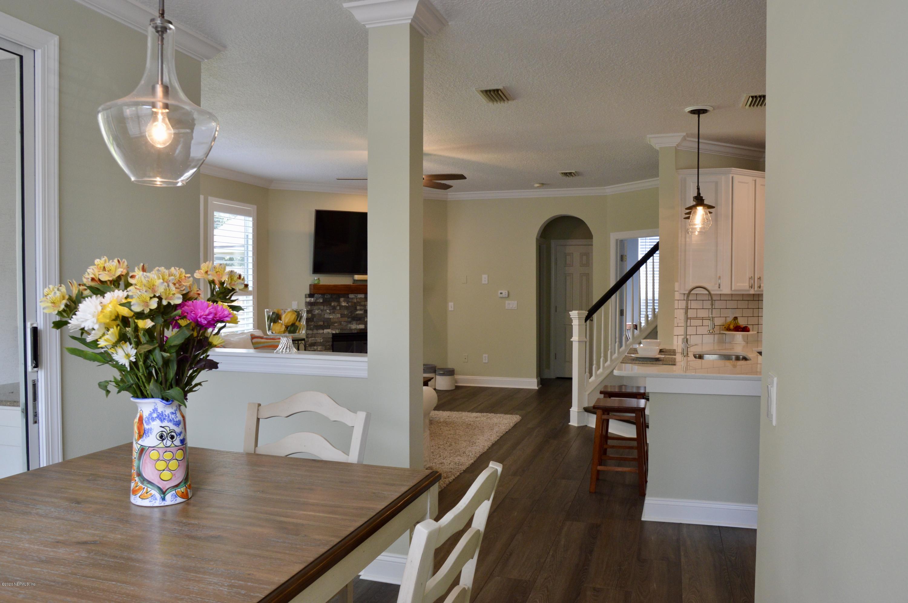 3412 South Saxxon Road St. Augustine, FL 32092 - Photo 8 of 23 a view of a dining room with furniture and a chandelier