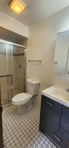 a bathroom with a toilet a sink and shower