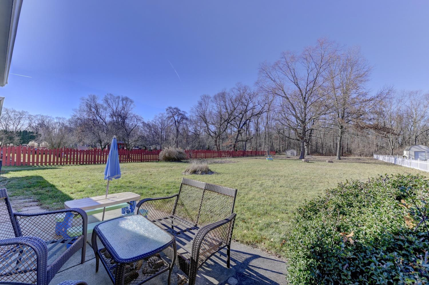 12134 North 332E Thayer, IN 46381 - Photo 14 of 16 a view of a garden with a table and chairs