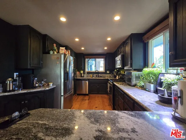 a kitchen with refrigerator and cabinets