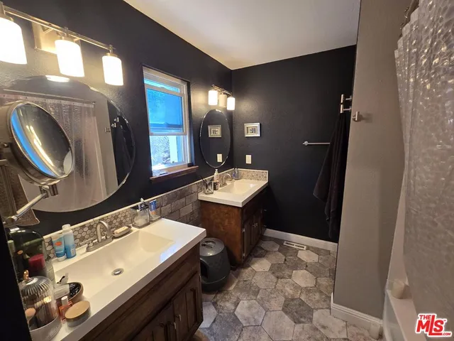 a bathroom with a double vanity sink and a mirror