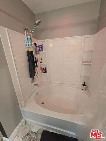 a bathroom with a bathtub and a shower