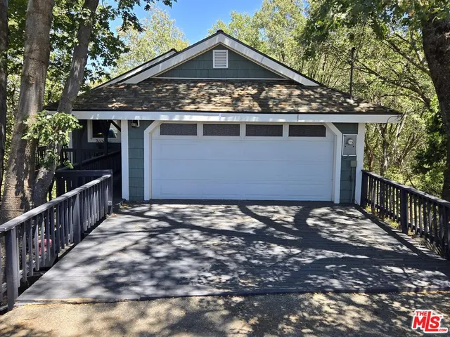 a view of a house with wooden fence