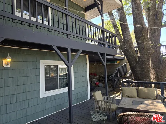 a view of balcony with table and chairs