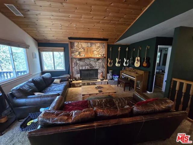 a living room with furniture a flat screen tv and a large window