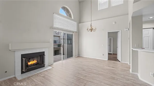 a view of an empty room with a fireplace and a window