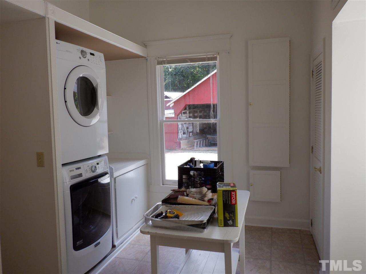 1516 Bahama Road Bahama, NC 27503 - Photo 10 of 25 Oversized laundry room with washer, dryer, built in ironing board & storage for iron, and closets & cubbies galore