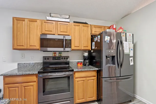 a kitchen with granite countertop a sink and cabinets