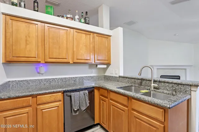 a view of an empty room with closet and a window