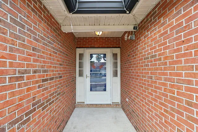 a view of entryway with brick walls