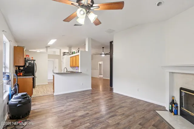 a view of a living room a window and wooden floor