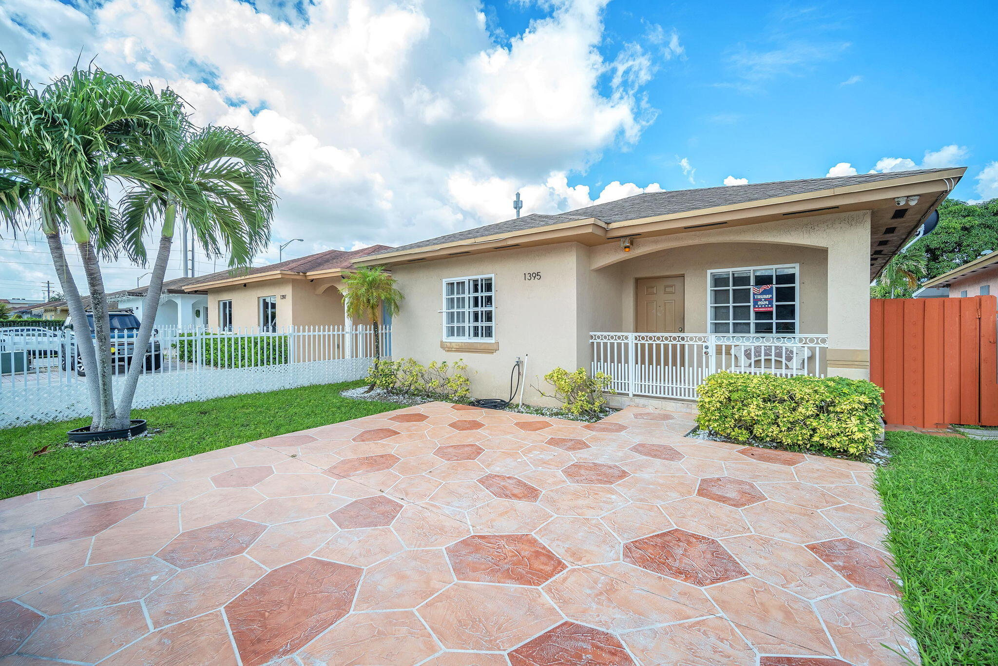 1395 West 30th Street Hialeah, FL 33012 - Photo 1 of 26 a front view of a house with garden