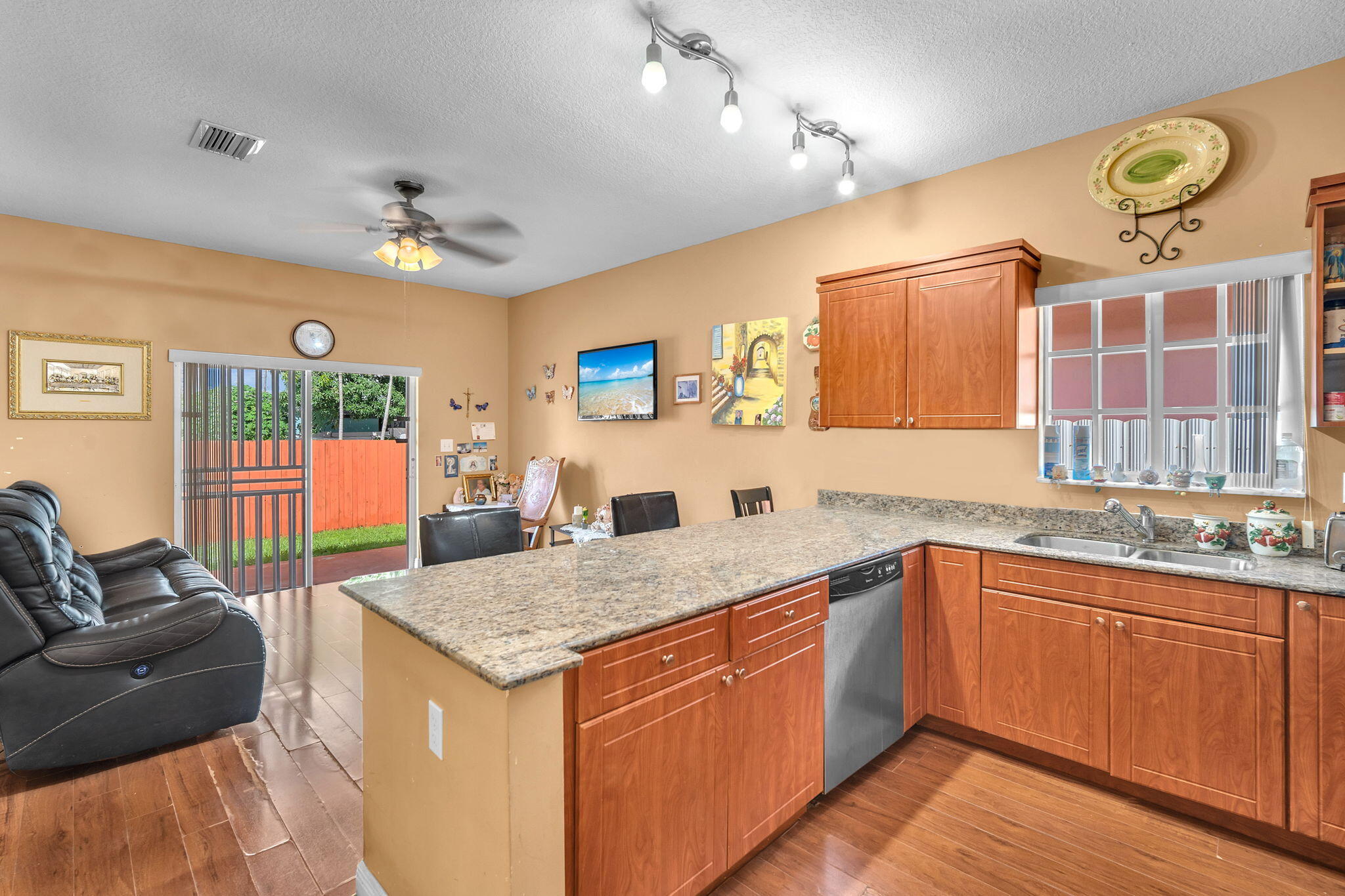 1395 West 30th Street Hialeah, FL 33012 - Photo 14 of 26 a open kitchen with stainless steel appliances granite countertop a sink dishwasher stove and refrigerator with wooden floor