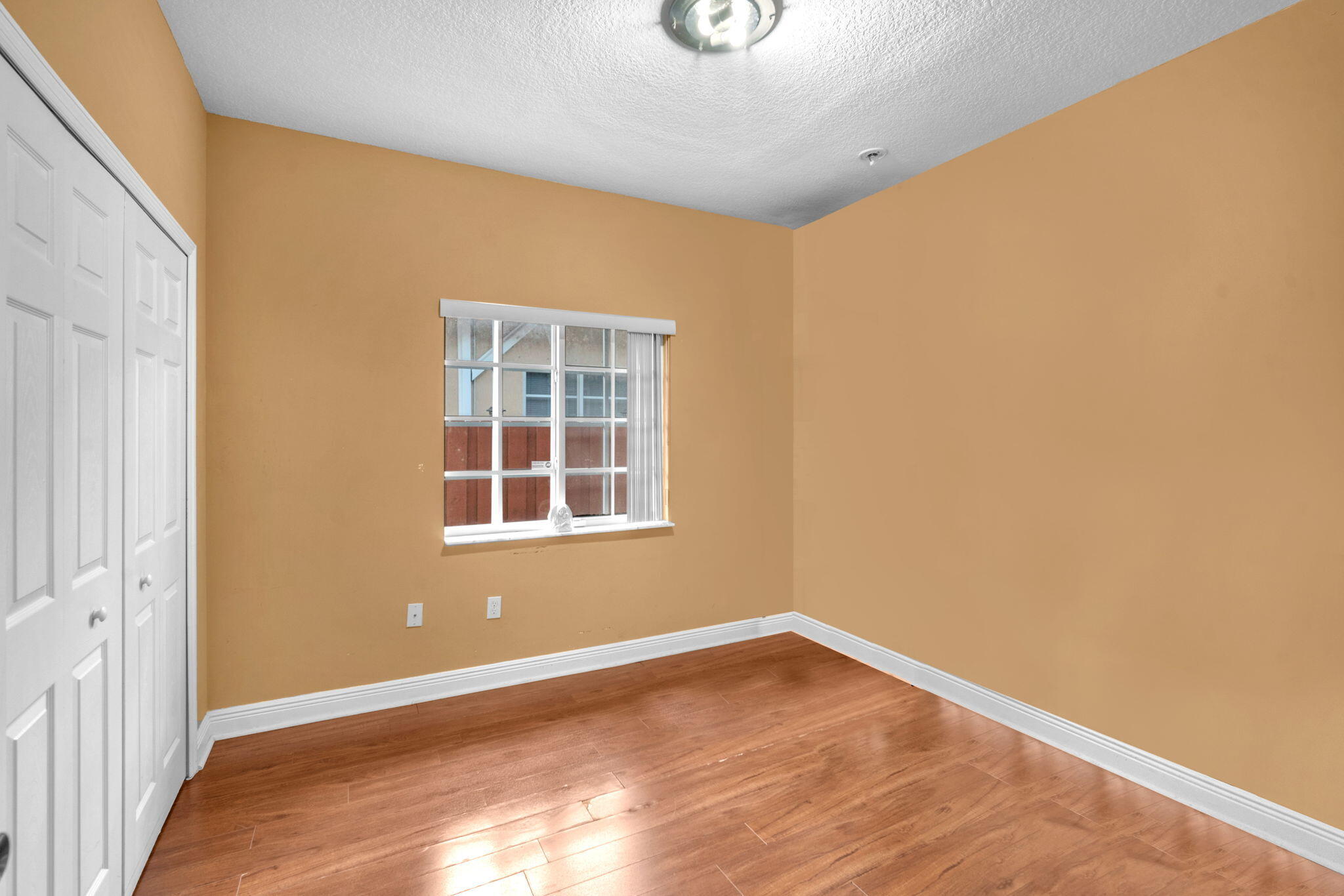 1395 West 30th Street Hialeah, FL 33012 - Photo 23 of 26 a view of empty room with wooden floor and fan