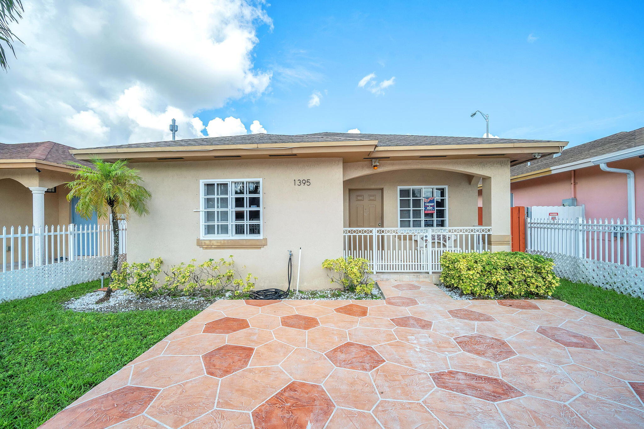 1395 West 30th Street Hialeah, FL 33012 - Photo 9 of 26 a front view of a house with garden