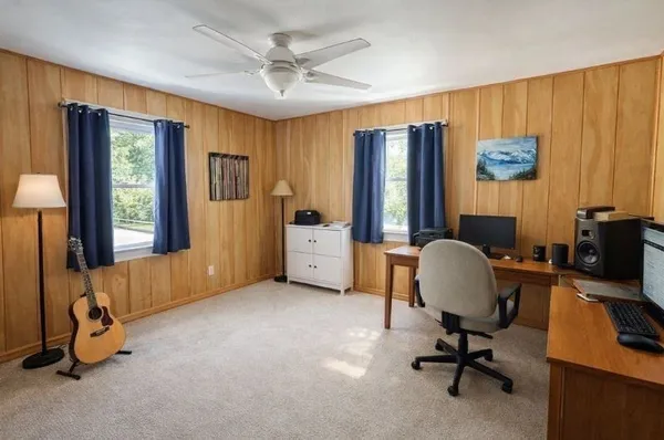 a view of a workspace with furniture and a window