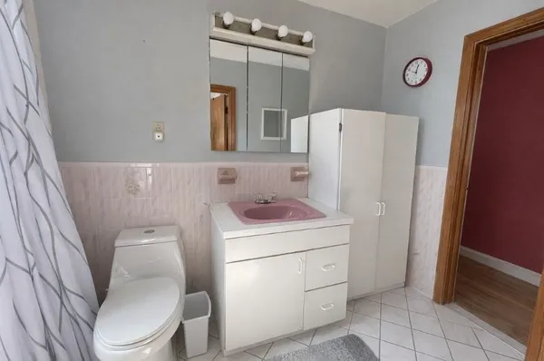 a bathroom with a sink a toilet and a mirror