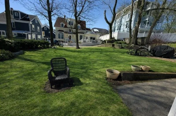 a backyard of a house with table and chairs