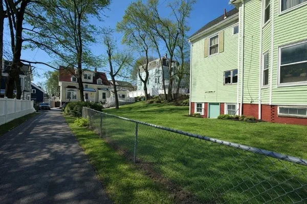 a view of backyard of house with green space