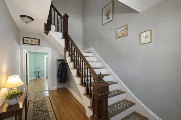 a view of entryway and hall with wooden floor