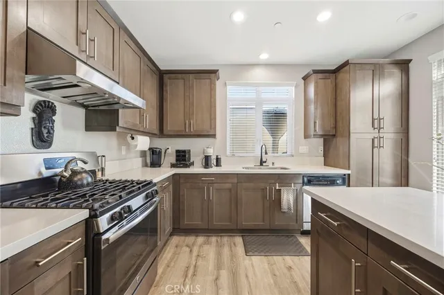 a kitchen with a sink stove top oven and cabinets
