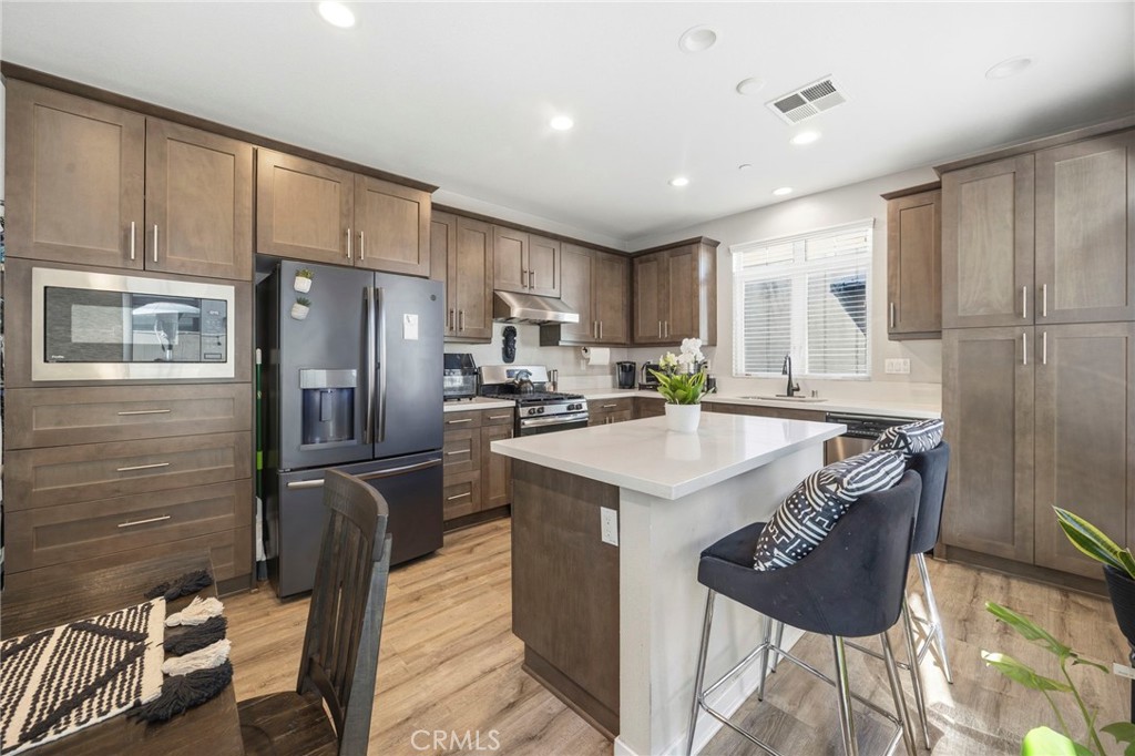 2049 North Orange Olive Road Orange, CA 92865 - Photo 14 of 36 a kitchen with stainless steel appliances granite countertop a sink refrigerator and cabinets
