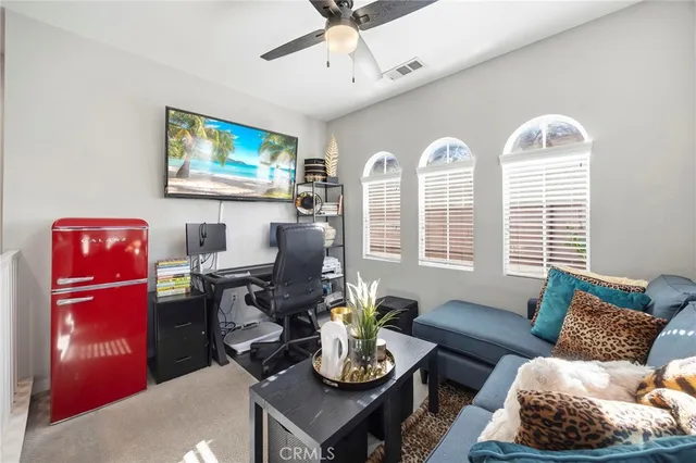 a living room with furniture flowerpot and window