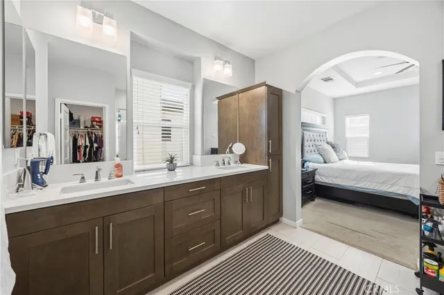 a en suite bathroom with a double vanity sink a mirror and a shower