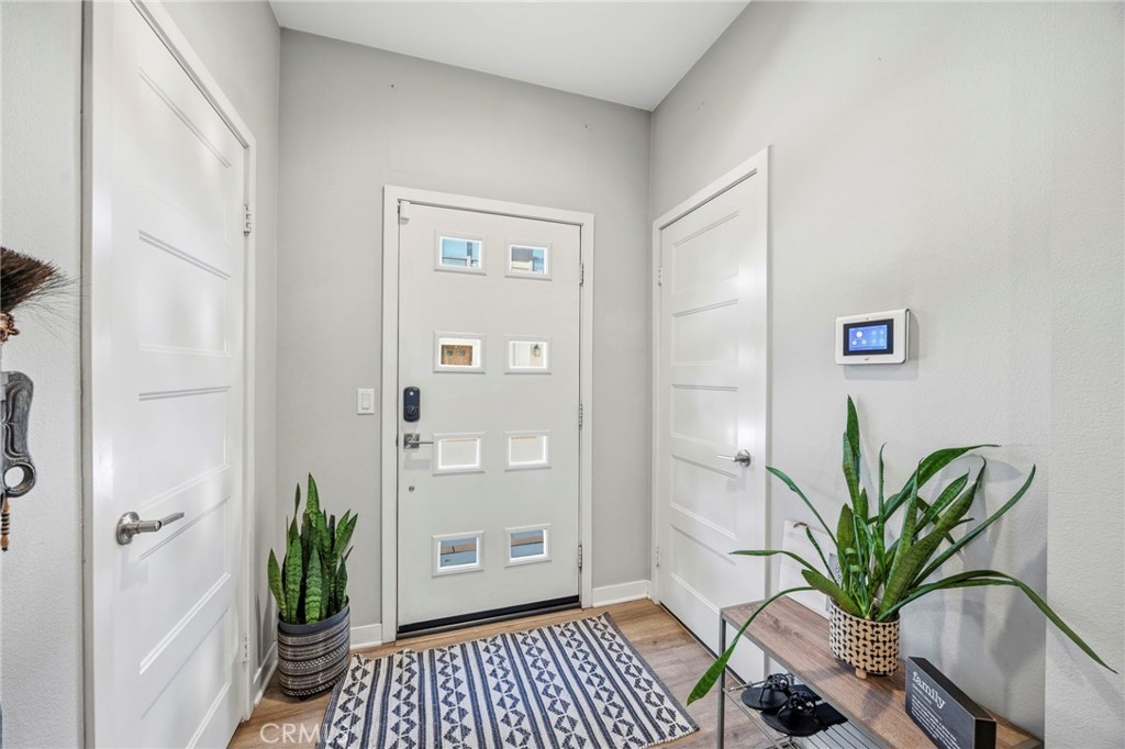 2049 North Orange Olive Road Orange, CA 92865 - Photo 4 of 36 a view of a hallway with wooden floor and a potted plant