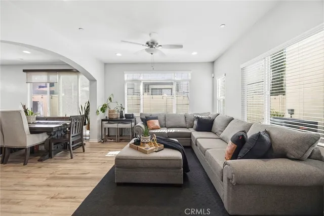 a living room with furniture wooden floor and windows